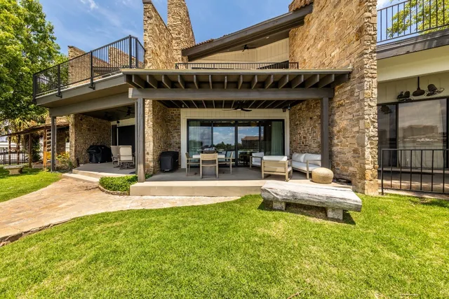 a view of a house with swimming pool and sitting area