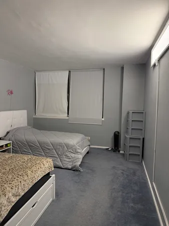 a bedroom with bed and window