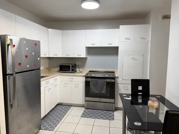 a kitchen with stainless steel appliances a stove a refrigerator and island