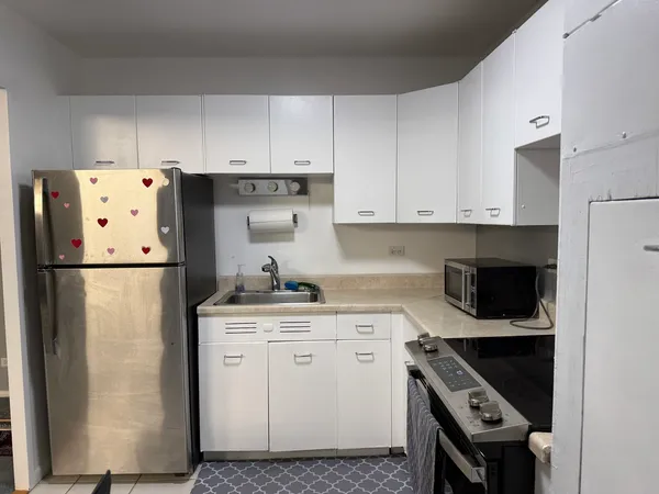 a kitchen with a white cabinets and white appliances