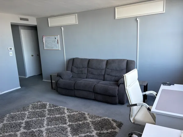 a living room with furniture and a rug