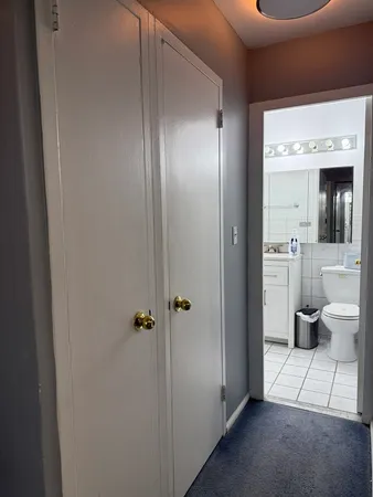a view of a bathroom with a glass door and a window