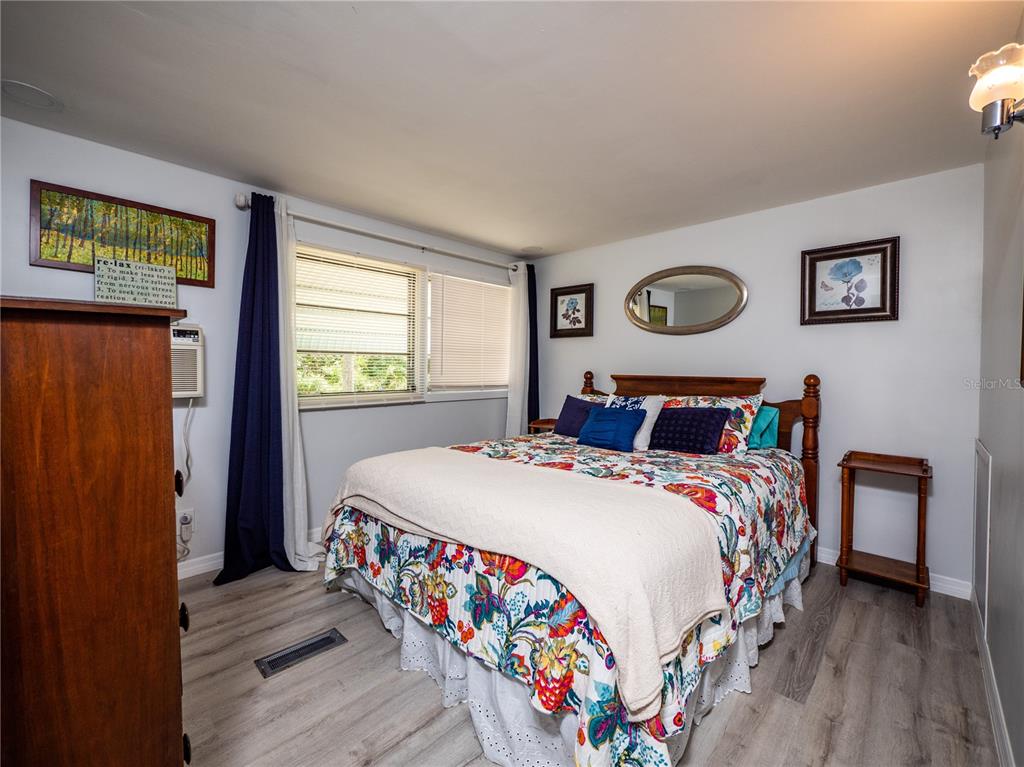 23673 Northeast 134th Lane Road Fort McCoy, FL 32134 - Photo 13 of 34 a bedroom with bed and a window