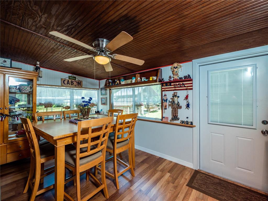 23673 Northeast 134th Lane Road Fort McCoy, FL 32134 - Photo 16 of 34 a view of a dining room with furniture window and outside view