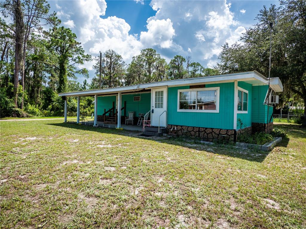 23673 Northeast 134th Lane Road Fort McCoy, FL 32134 - Photo 17 of 34 a view of a house with a yard