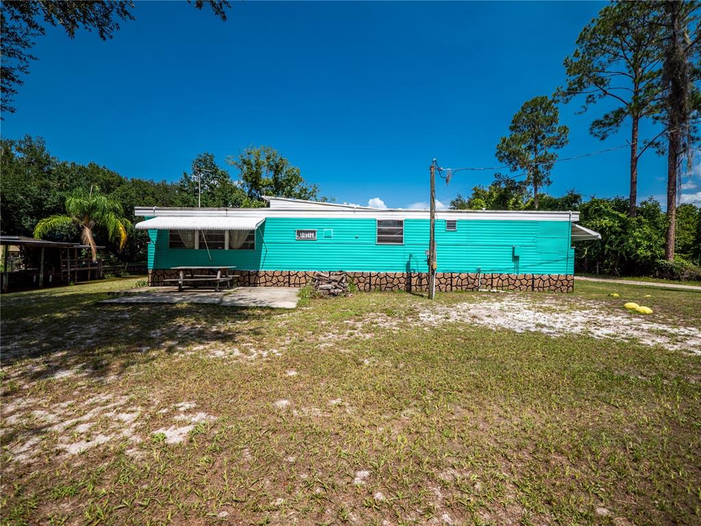 23673 Northeast 134th Lane Road Fort McCoy, FL 32134 - Photo 18 of 34 a view of a house with a yard