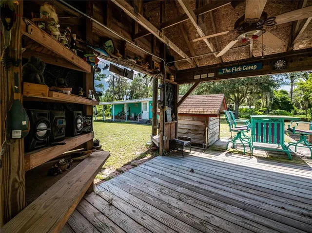 a view of deck with furniture and trees