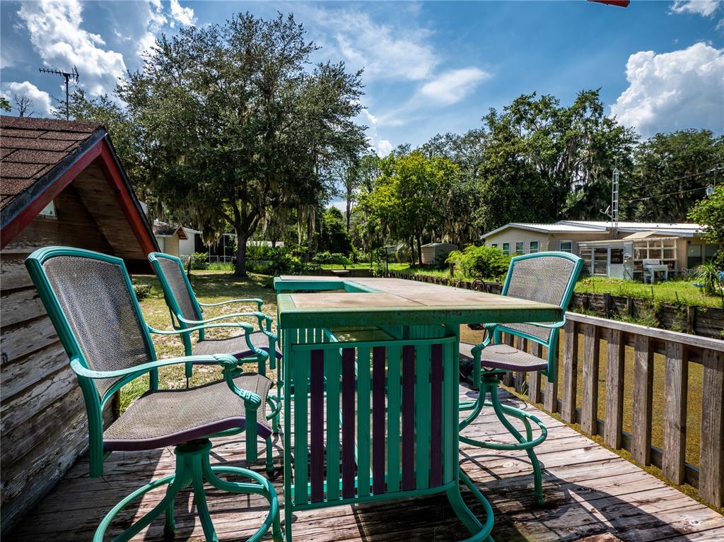 23673 Northeast 134th Lane Road Fort McCoy, FL 32134 - Photo 26 of 34 a view of deck with furniture and trees