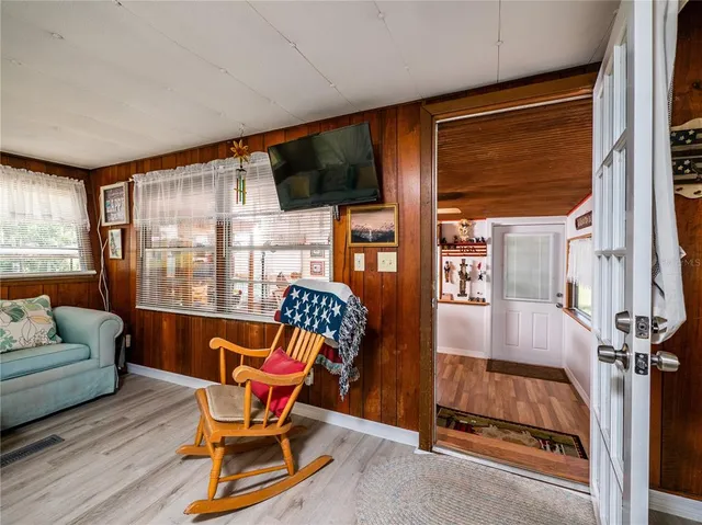 a room with musical instrument pool table and windows