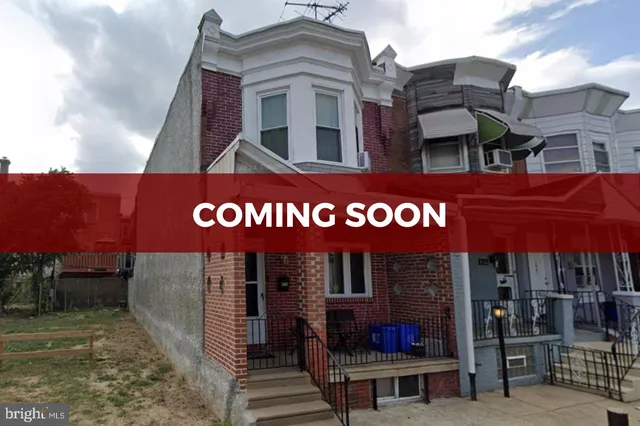 a view of a cafe with a table and chairs under an umbrella