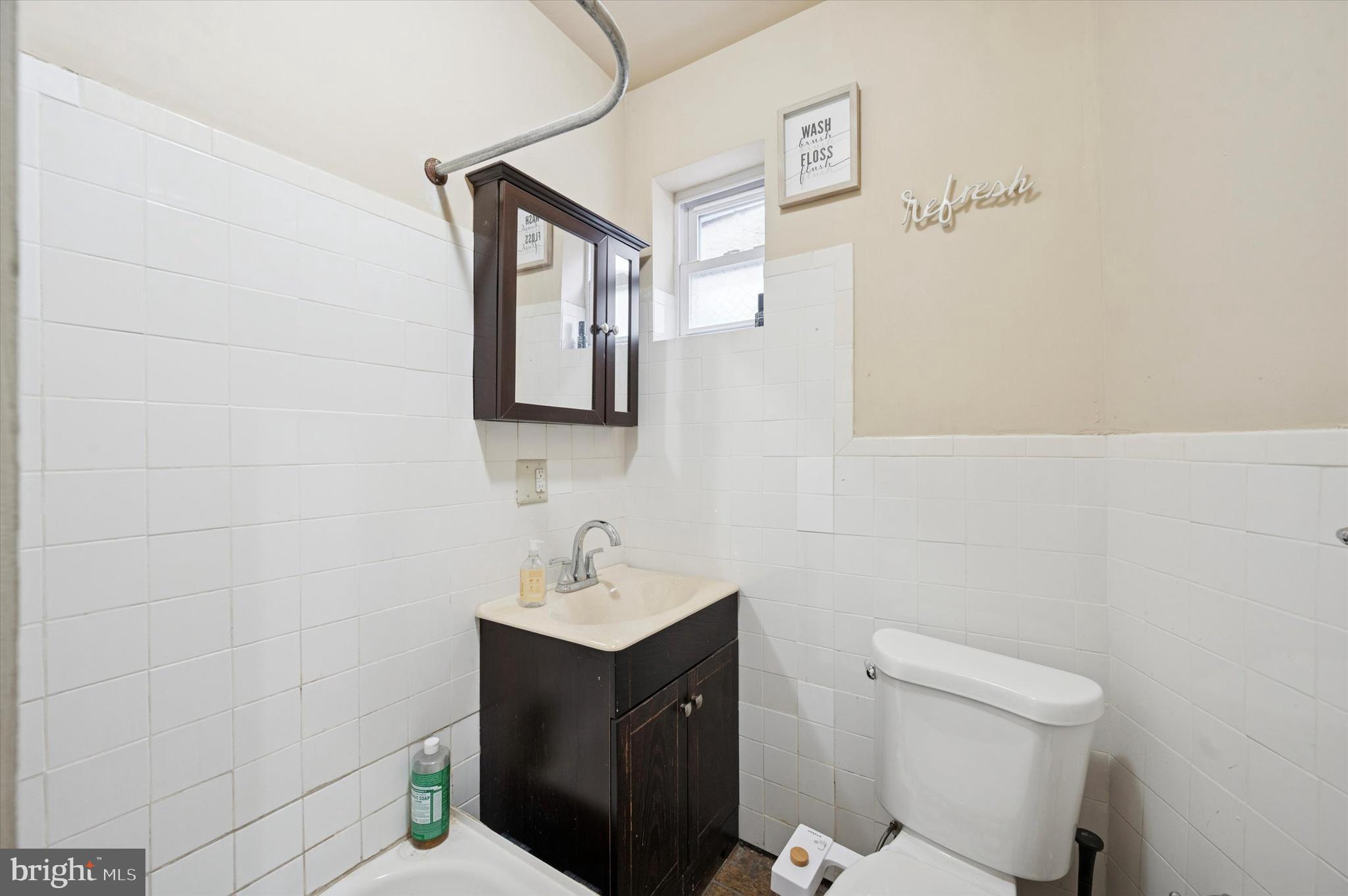 1404 North Felton Street Philadelphia, PA 19151 - Photo 14 of 15 a bathroom with a toilet sink and mirror