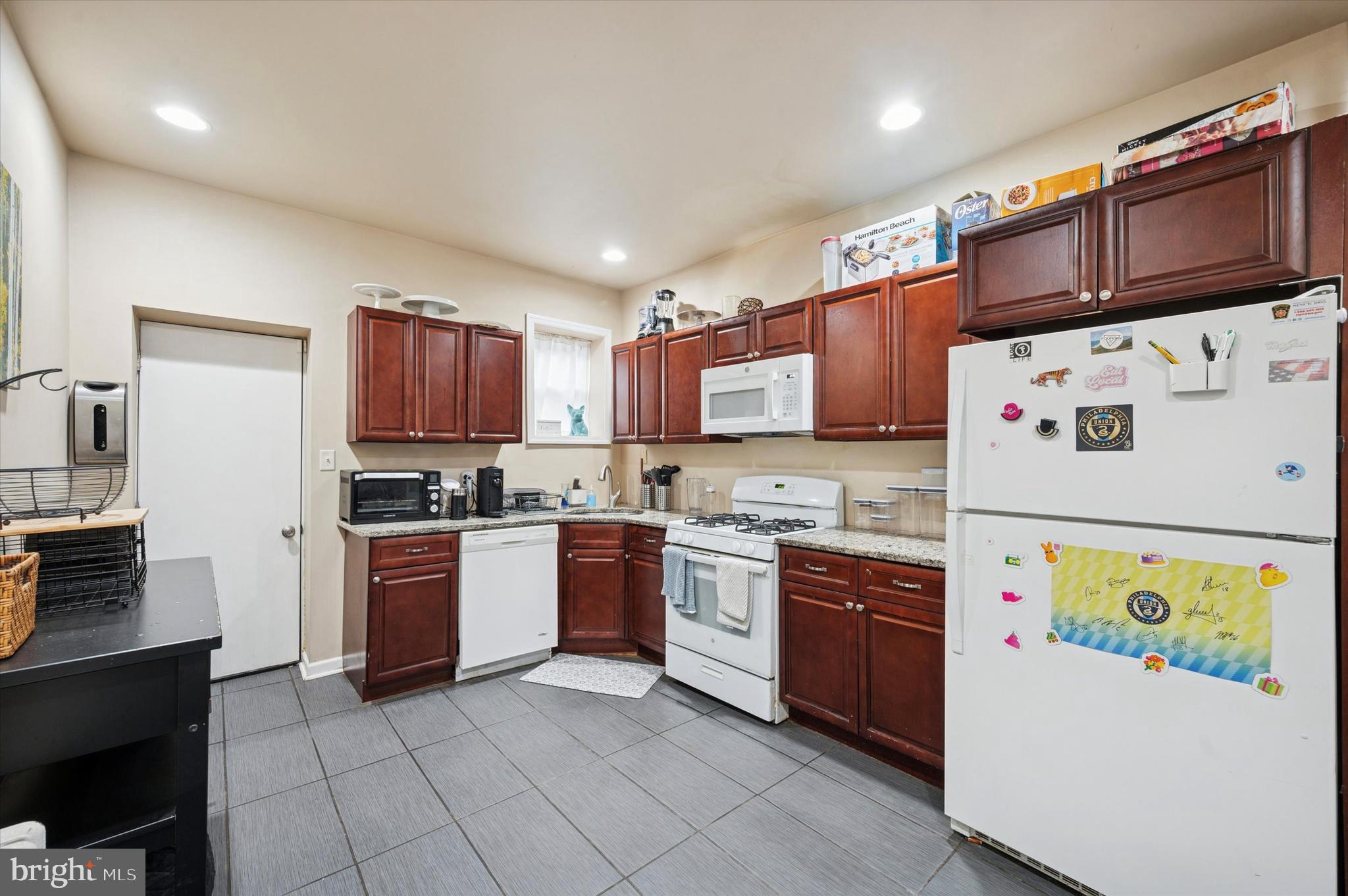 1404 North Felton Street Philadelphia, PA 19151 - Photo 7 of 15 a kitchen with stainless steel appliances and cabinets