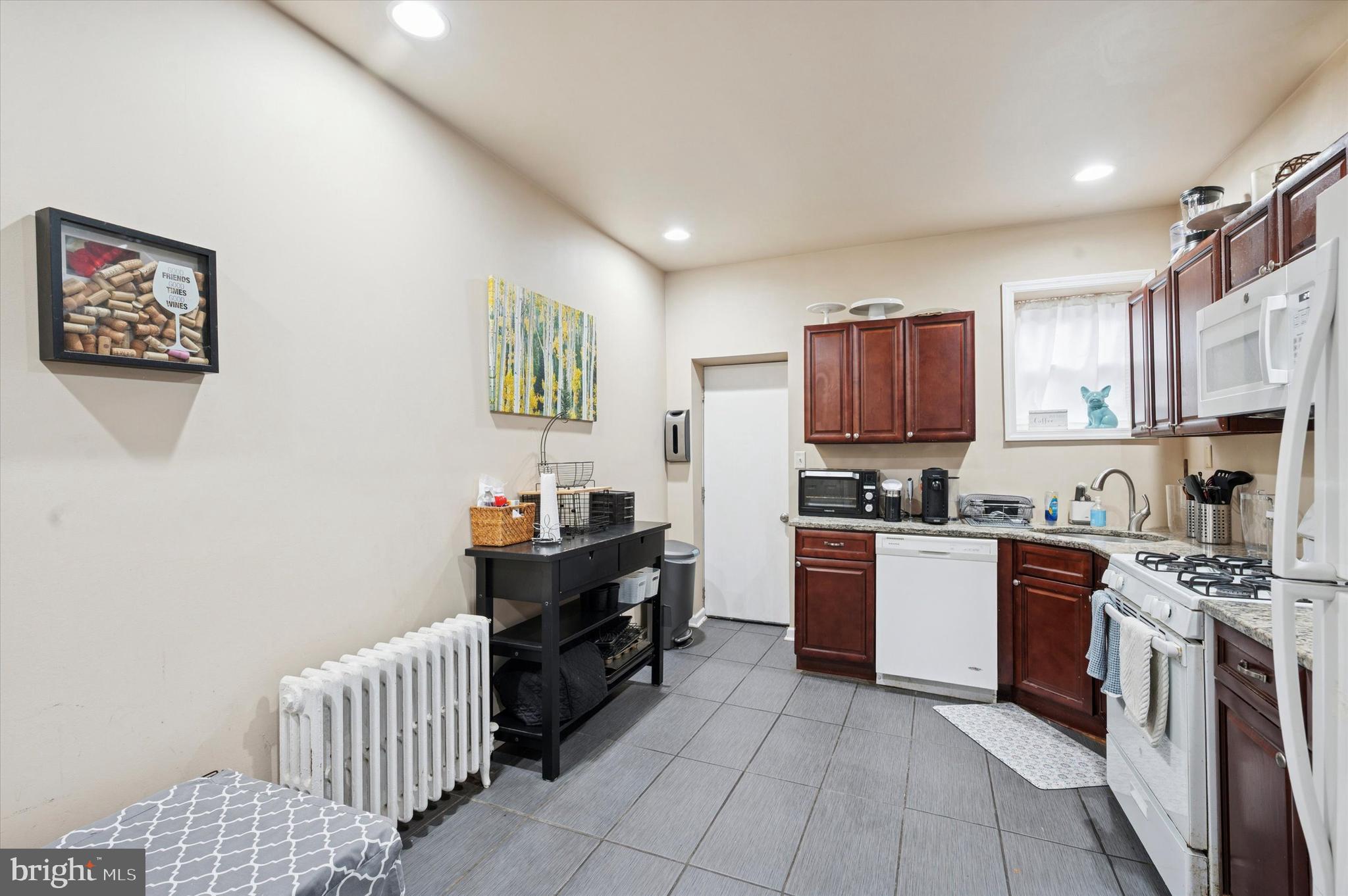 1404 North Felton Street Philadelphia, PA 19151 - Photo 8 of 15 a kitchen with stainless steel appliances granite countertop a stove top oven a sink dishwasher and a refrigerator