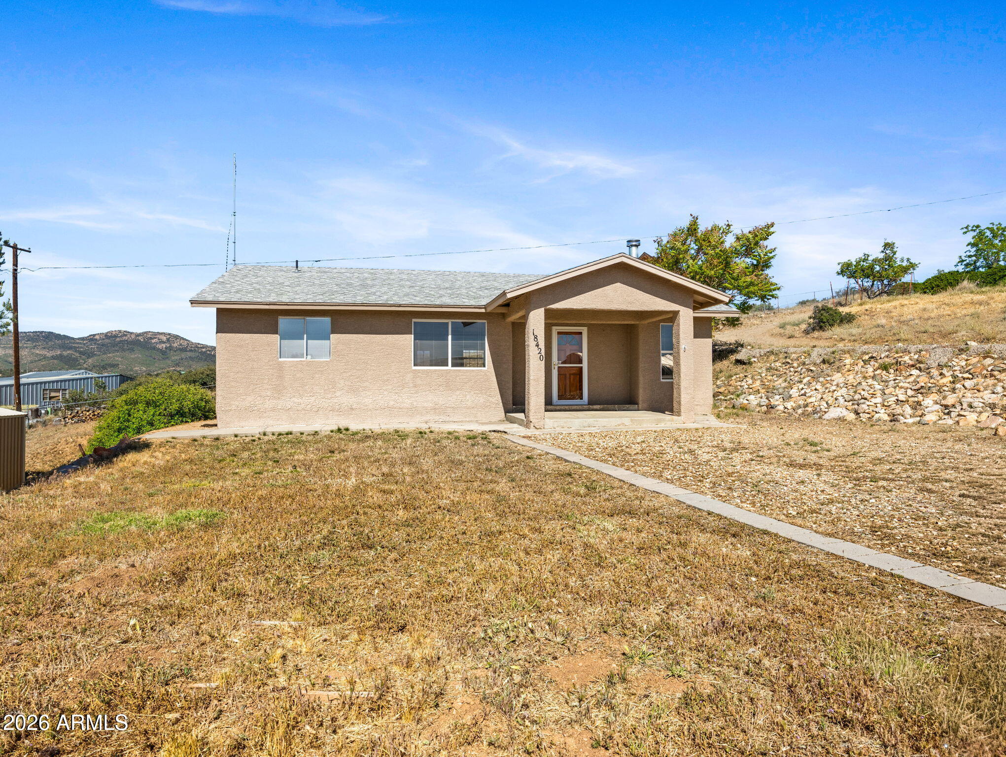 18420 Peeples Valley Road Peeples Valley, AZ 86332 - Photo 1 of 31 a front view of a house with a yard