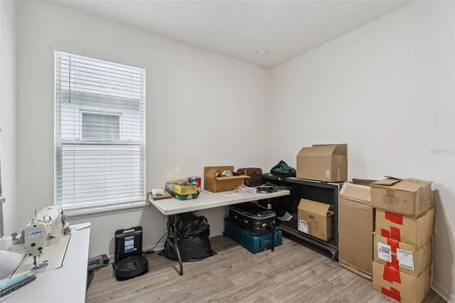 a view of a workspace with furniture and a window