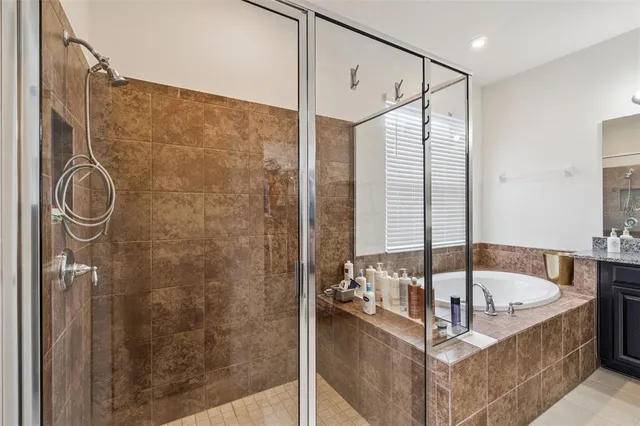 a bathroom with a tub and a shower