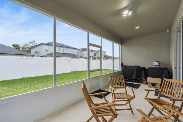 a view of an chairs and table in the patio