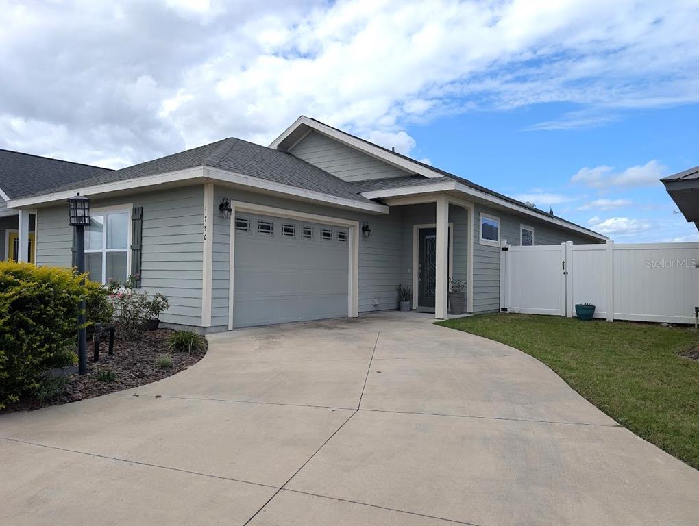 1750 Southwest 246th Drive Newberry, FL 32669 - Photo 1 of 18 a front view of a house with garden