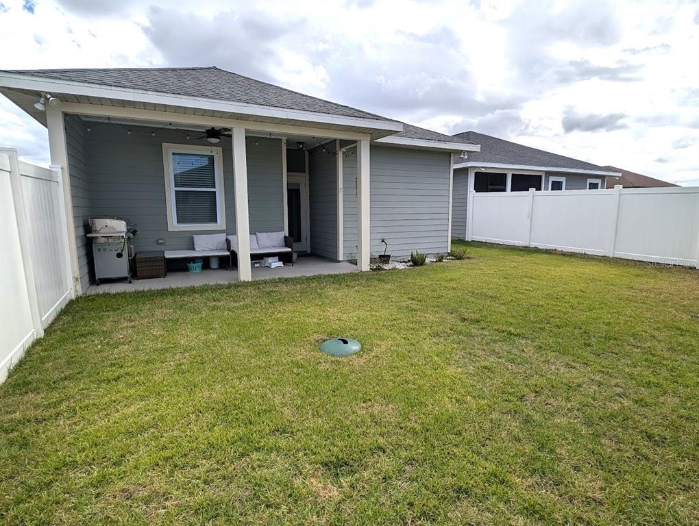 1750 Southwest 246th Drive Newberry, FL 32669 - Photo 14 of 18 a backyard of a house with table and chairs