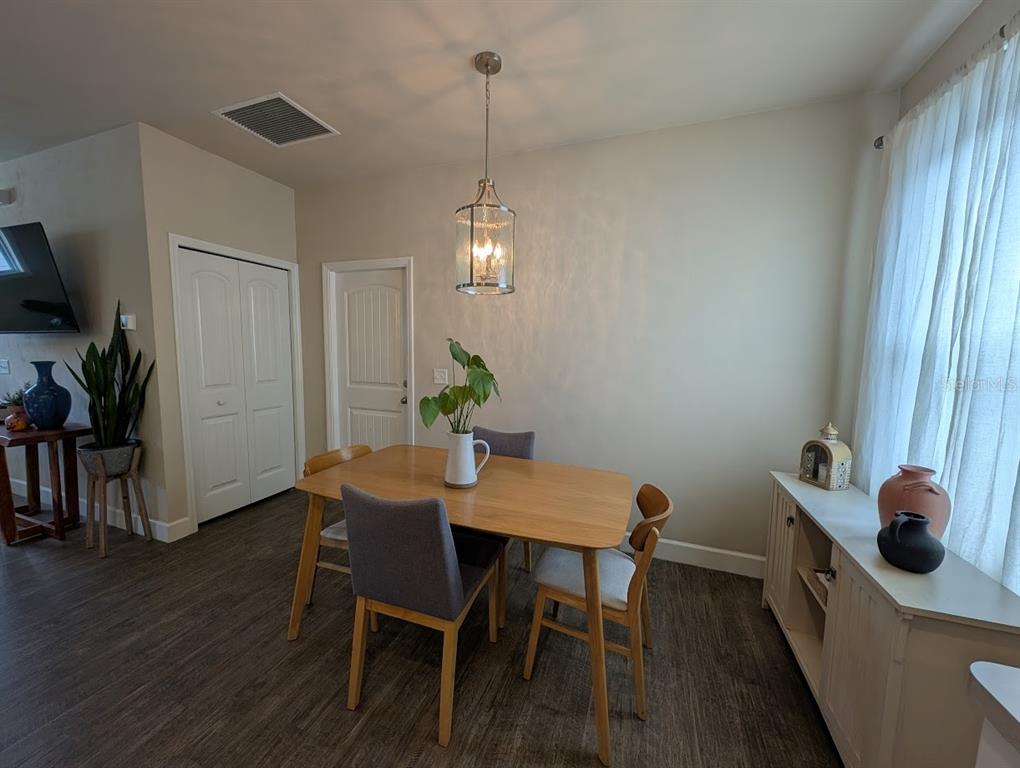 1750 Southwest 246th Drive Newberry, FL 32669 - Photo 6 of 18 a view of a dining room with furniture and wooden floor