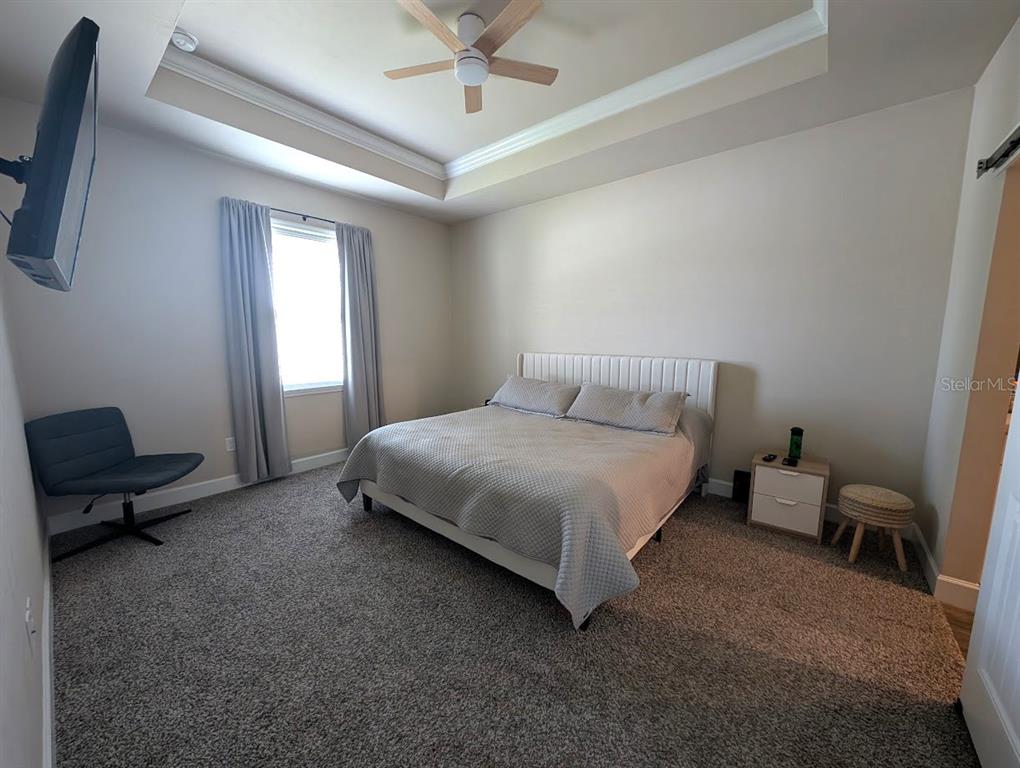 1750 Southwest 246th Drive Newberry, FL 32669 - Photo 10 of 18 a bedroom with a bed and a chair