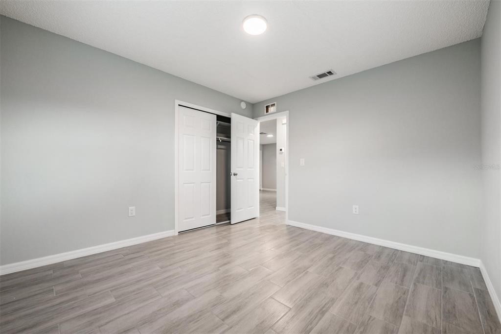 7802 Butler Avenue Hudson, FL 34667 - Photo 12 of 30 a view of an empty room with wooden floor