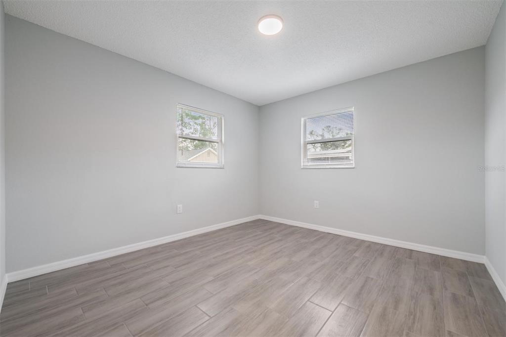 7802 Butler Avenue Hudson, FL 34667 - Photo 13 of 30 an empty room with wooden floor and windows