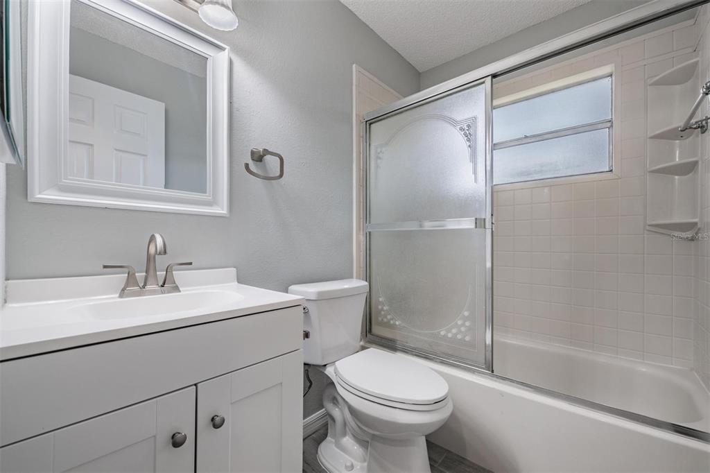 7802 Butler Avenue Hudson, FL 34667 - Photo 16 of 30 a bathroom with a sink toilet and shower