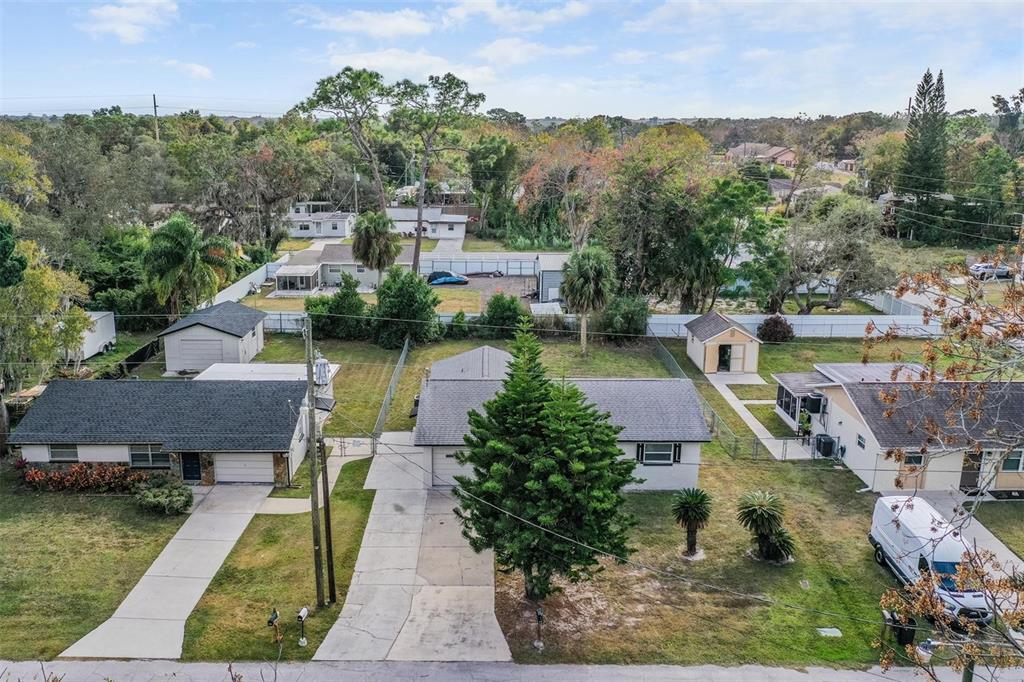 7802 Butler Avenue Hudson, FL 34667 - Photo 22 of 30 an aerial view of a house with swimming pool and lake view