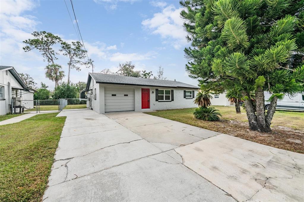 7802 Butler Avenue Hudson, FL 34667 - Photo 27 of 30 a front view of a house with a garden