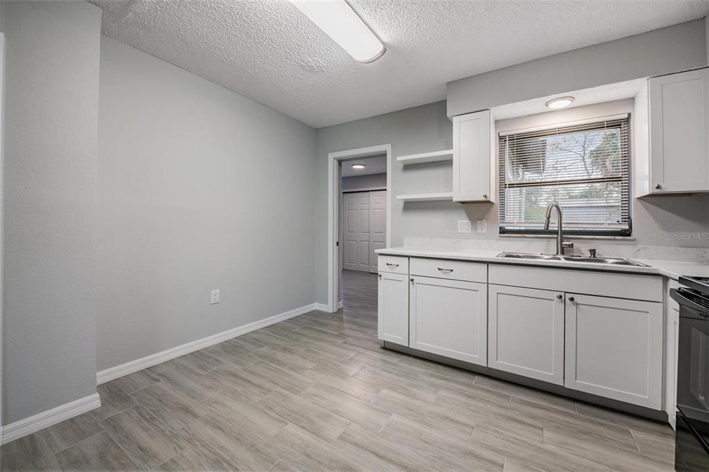 7802 Butler Avenue Hudson, FL 34667 - Photo 4 of 30 a kitchen with a sink cabinets and wooden floor