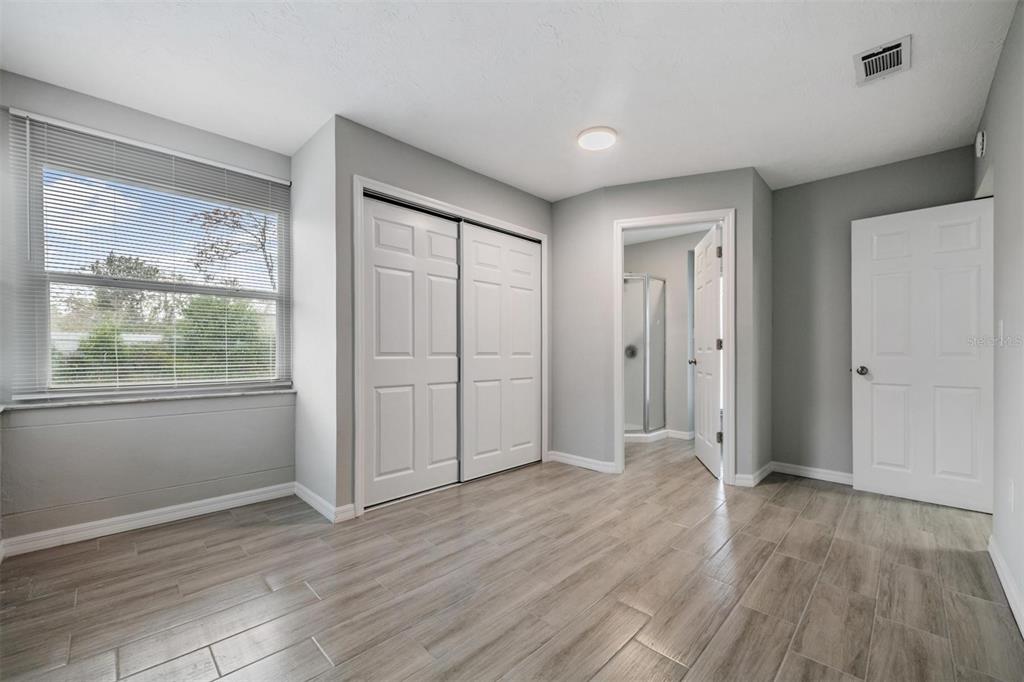 7802 Butler Avenue Hudson, FL 34667 - Photo 8 of 30 an empty room with wooden floor and windows