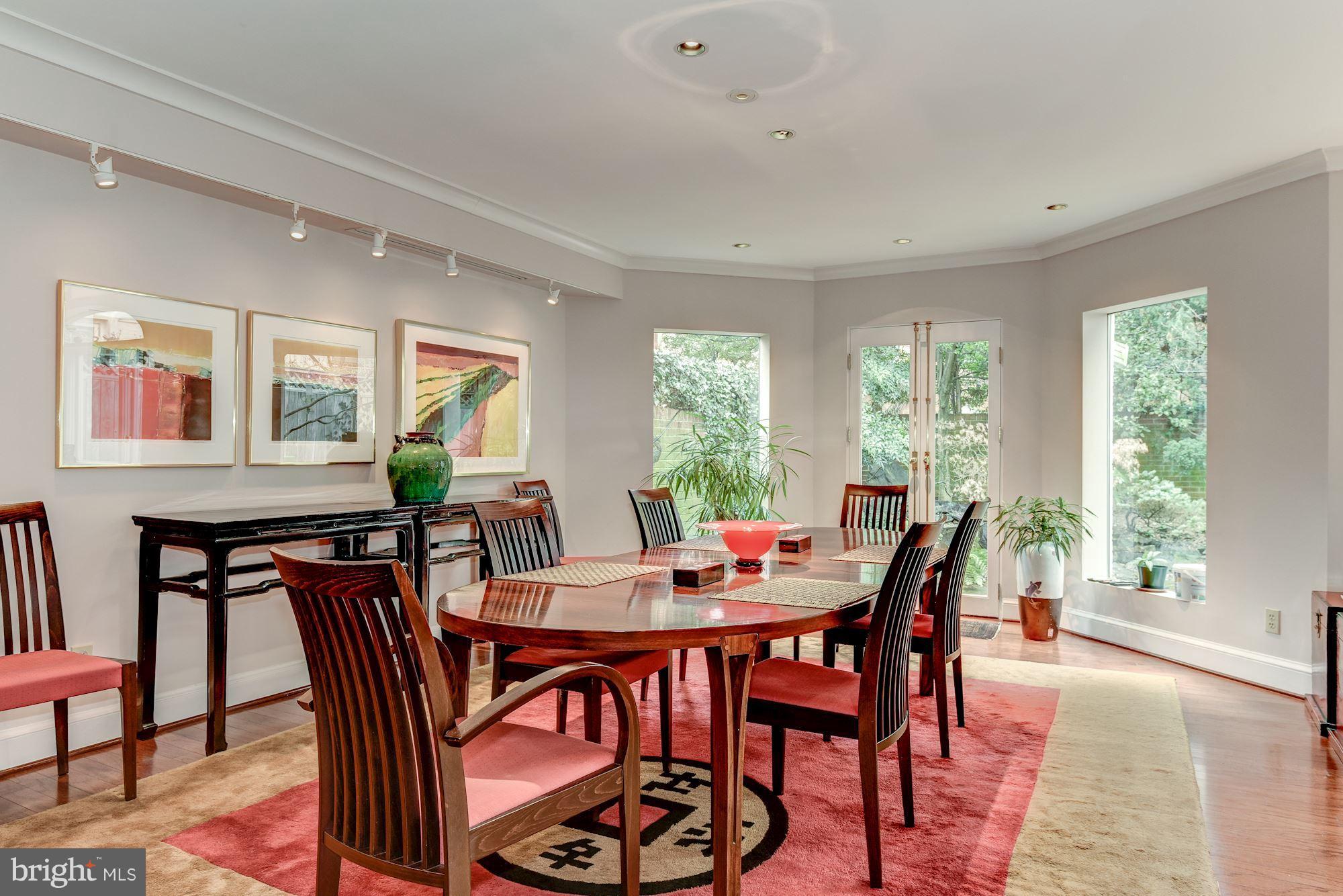 1610 32nd Street Northwest Washington, DC 20007 - Photo 18 of 27 a view of a dining room and livingroom with furniture a rug and a large window