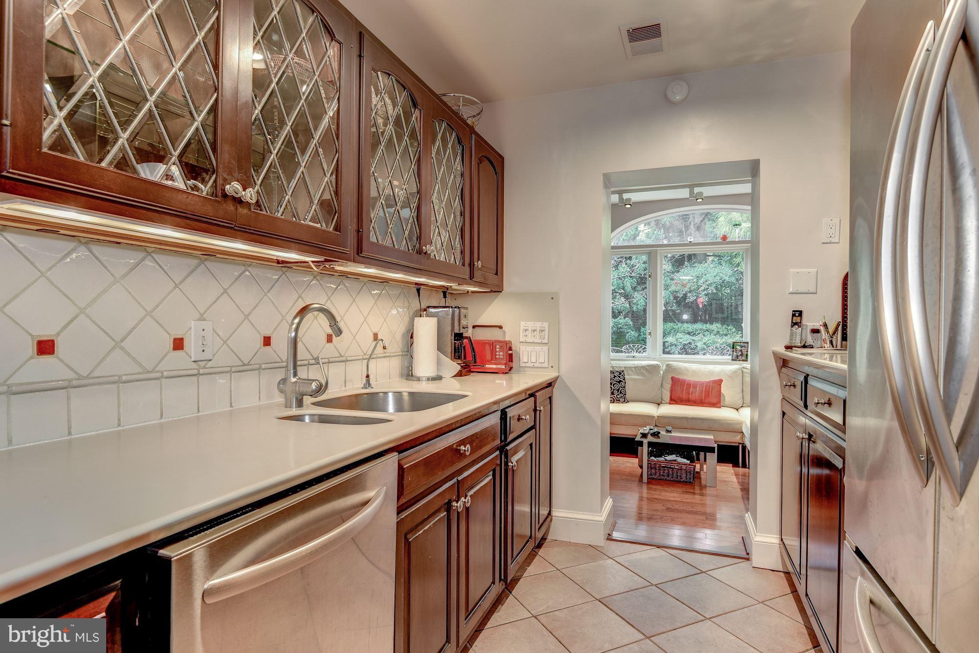 1610 32nd Street Northwest Washington, DC 20007 - Photo 22 of 27 a kitchen with stainless steel appliances a sink and cabinets