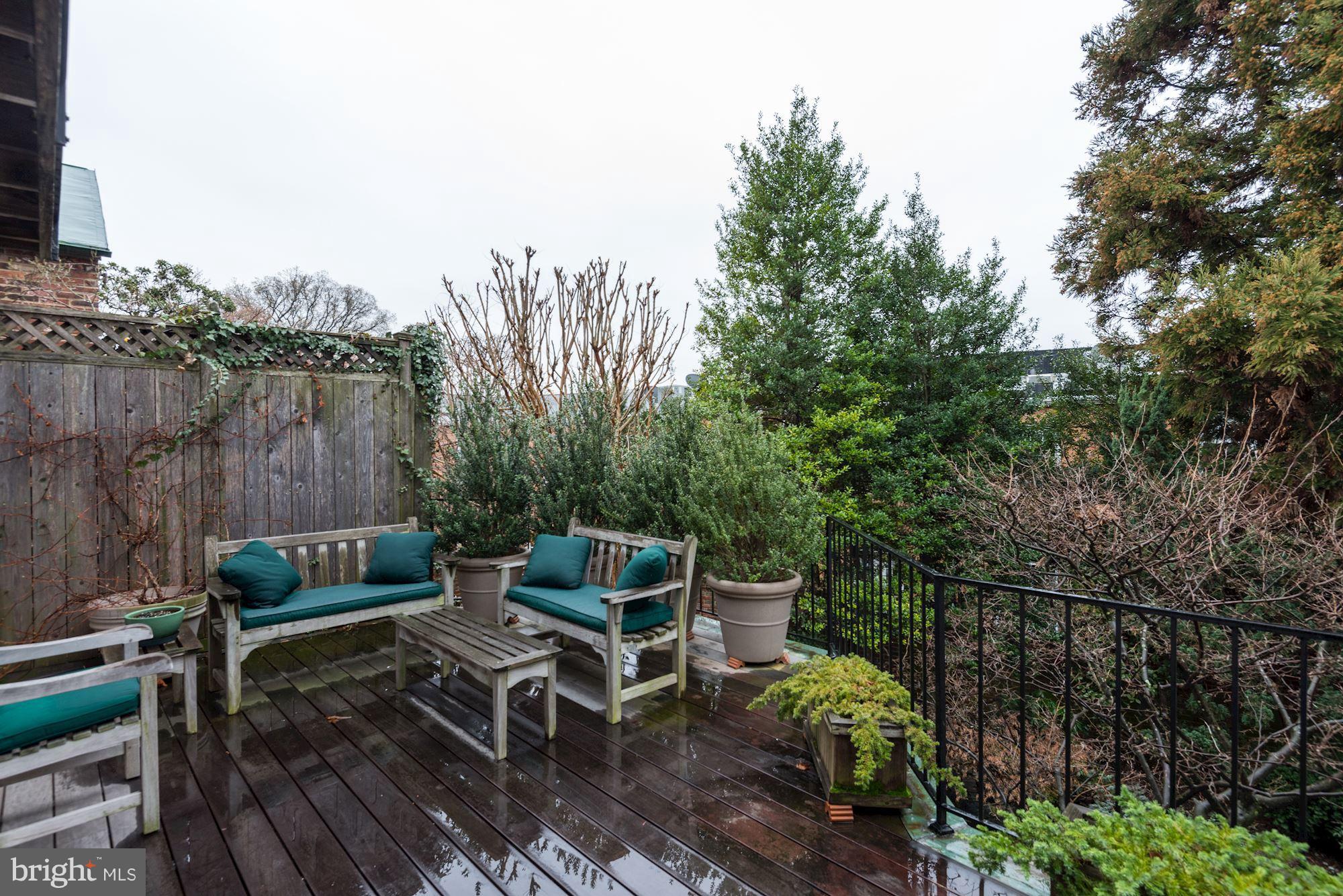 1610 32nd Street Northwest Washington, DC 20007 - Photo 6 of 27 a backyard of a house with table and chairs