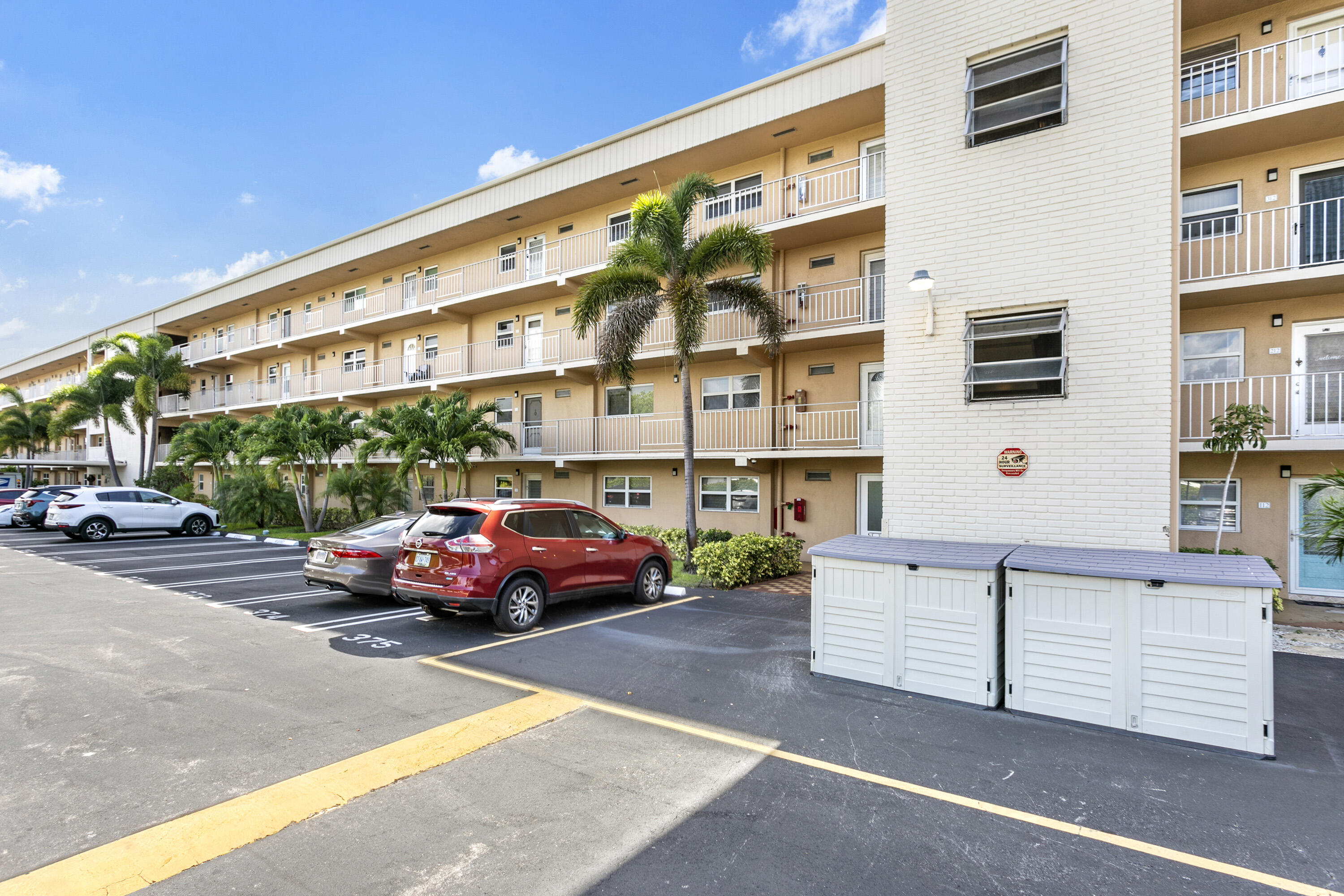 a front view of a building with parking