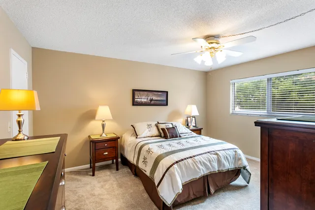 a bedroom with a bed and a chandelier