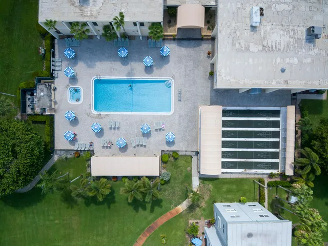 an aerial view of a house with a yard and lake view