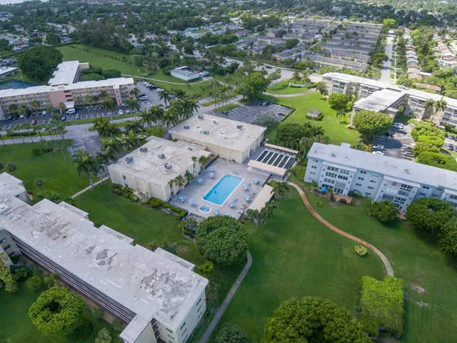 an aerial view of a house with a garden and lake view