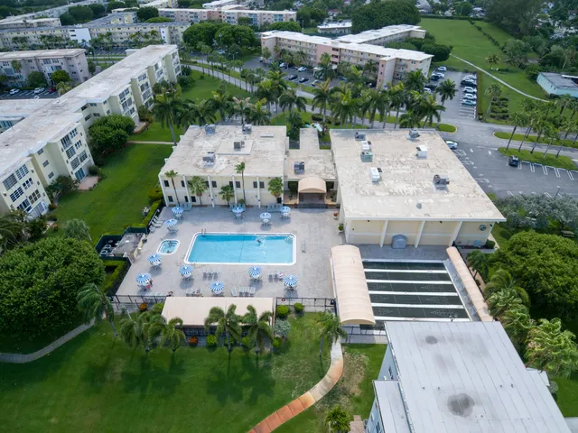 an aerial view of a house with garden space and street view