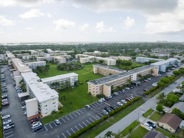 an aerial view of a house with garden space and street view