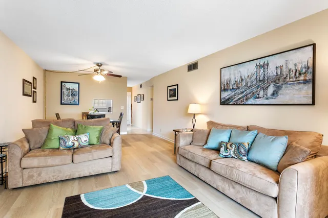 a living room with furniture and a painting