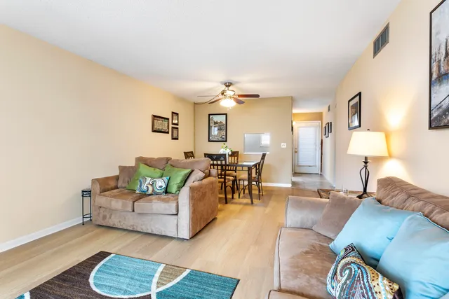 a living room with furniture and wooden floor