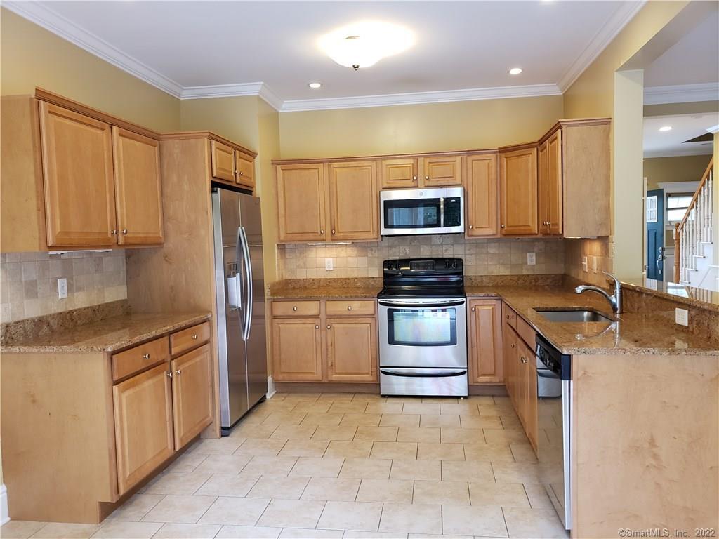 a kitchen with a sink stove and refrigerator