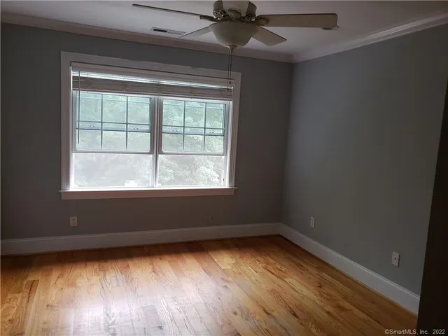 a view of a room with wooden floor and windows