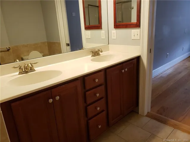 a bathroom with a double vanity sink and mirror