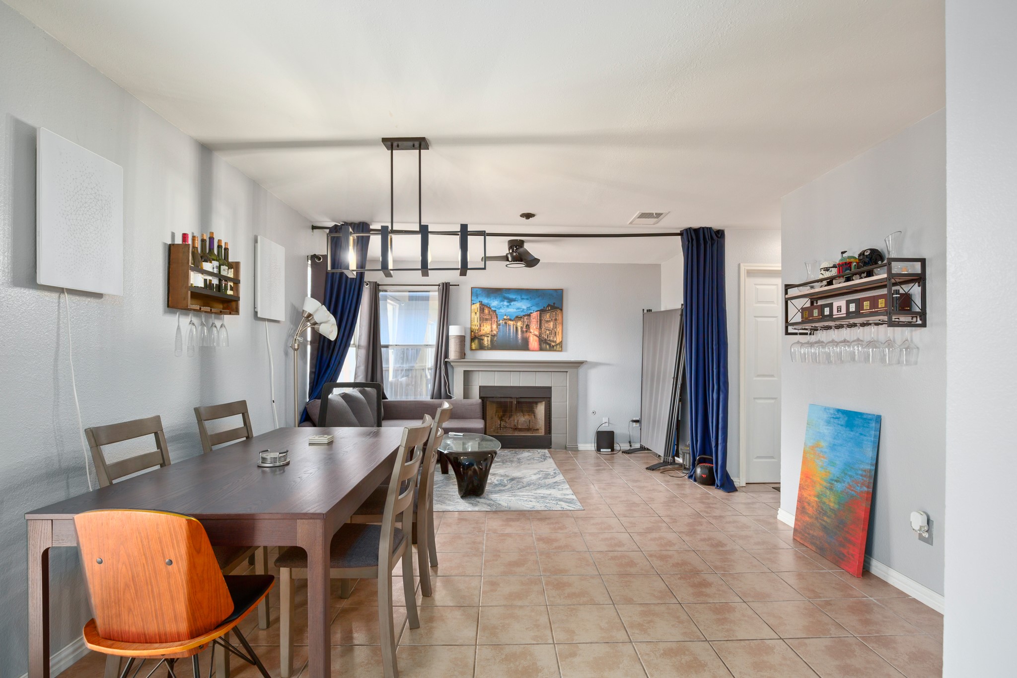 13803 Randalstone Drive Pflugerville, TX 78660 - Photo 14 of 27 Dining area featuring a tiled fireplace and light tile patterned floors