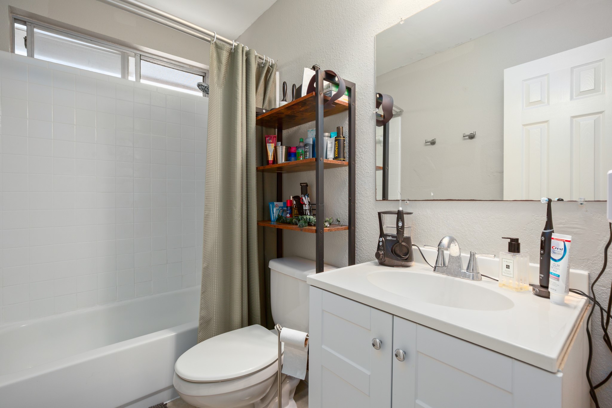 13803 Randalstone Drive Pflugerville, TX 78660 - Photo 21 of 27 Full bath with a textured wall, vanity, and shower / bathtub combination with curtain