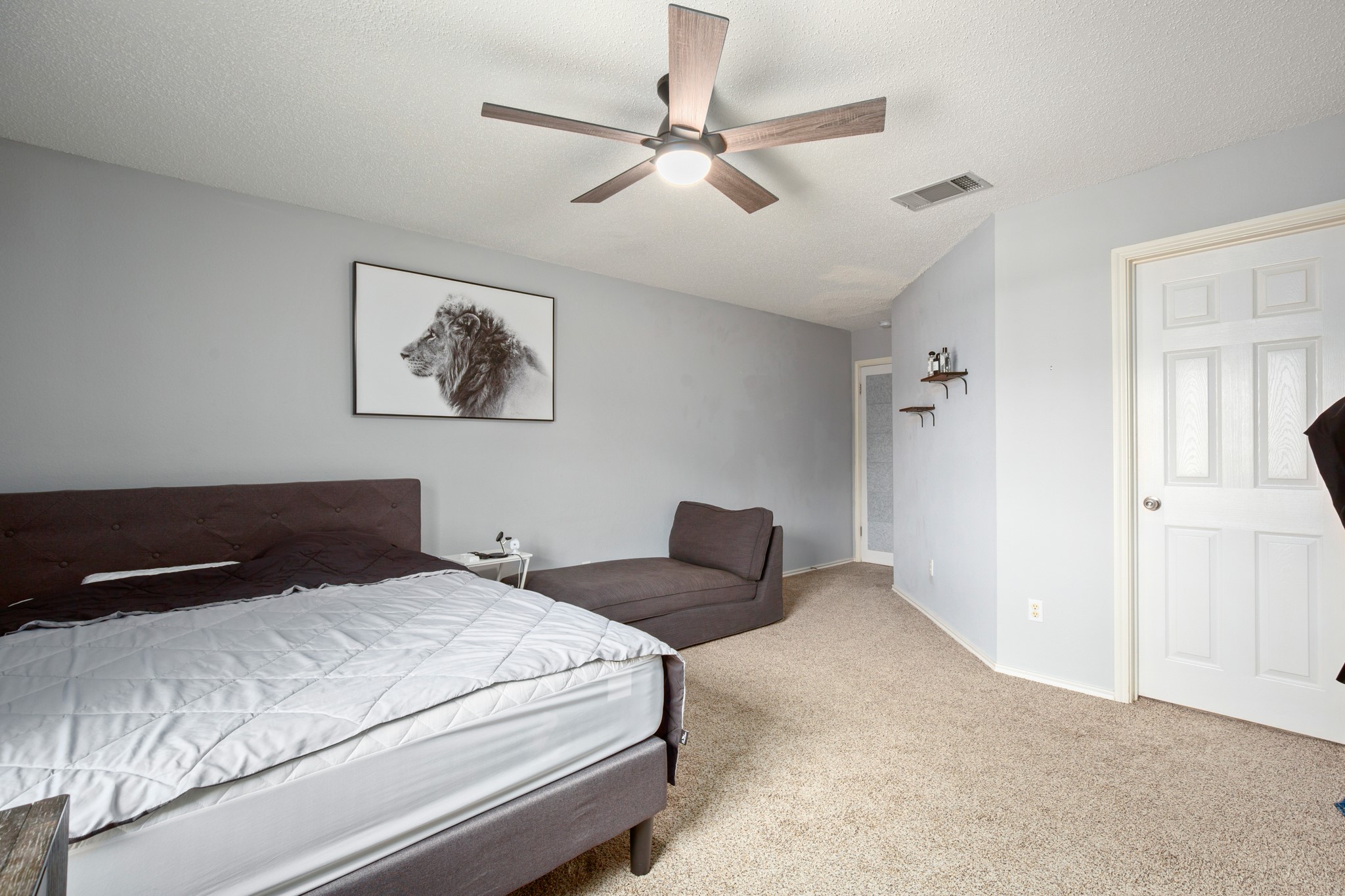 13803 Randalstone Drive Pflugerville, TX 78660 - Photo 27 of 27 Bedroom with light colored carpet, a ceiling fan, and a textured ceiling