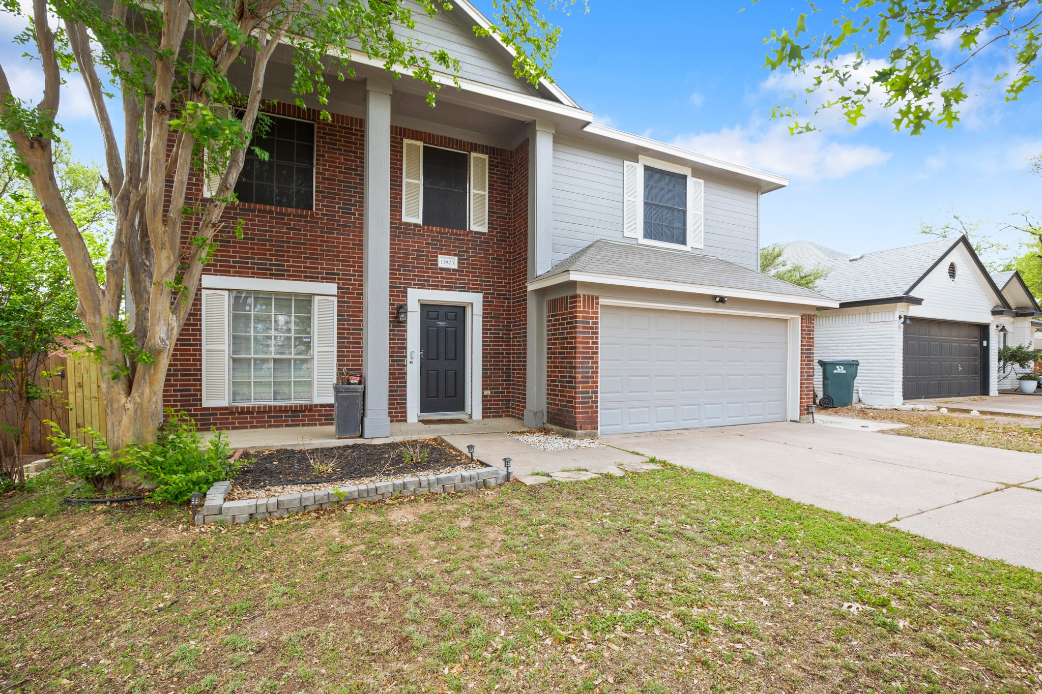 13803 Randalstone Drive Pflugerville, TX 78660 - Photo 3 of 27 View of front facade featuring covered porch, concrete driveway, a garage, and brick siding